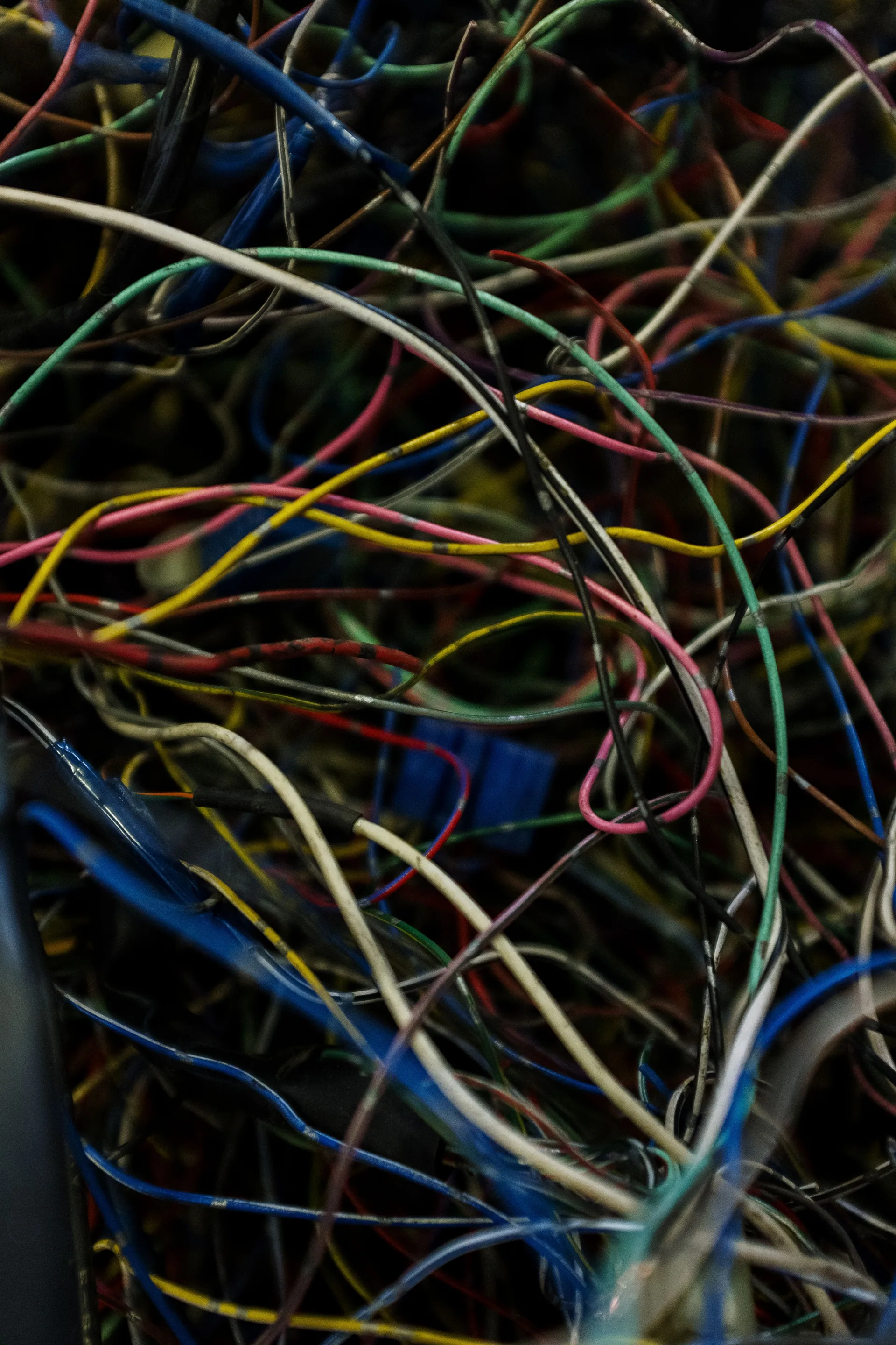 Close-up of tangled blue, red, and yellow electric wires