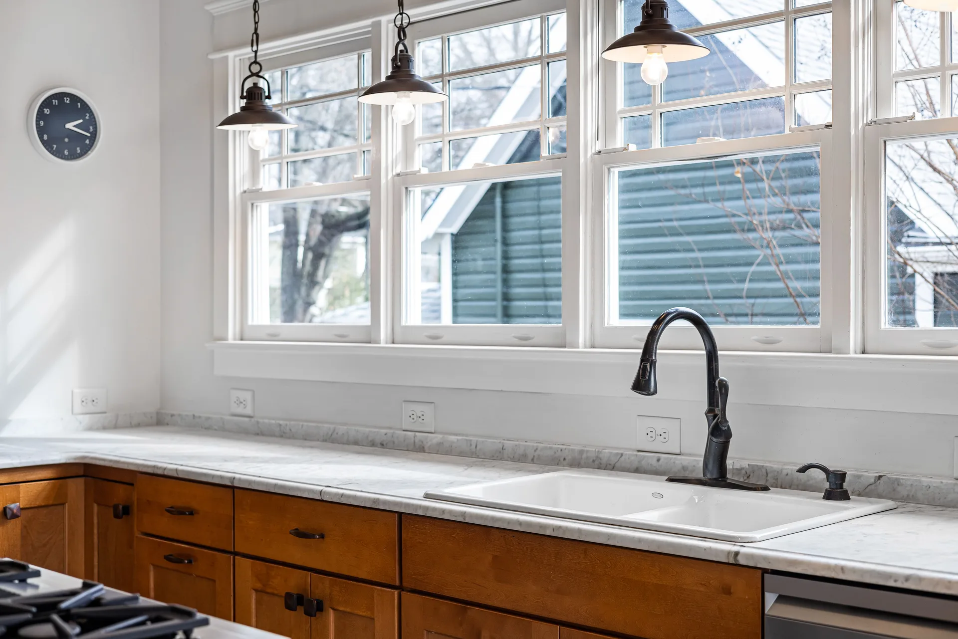 A bright kitchen with counters, cabinets, and a sink