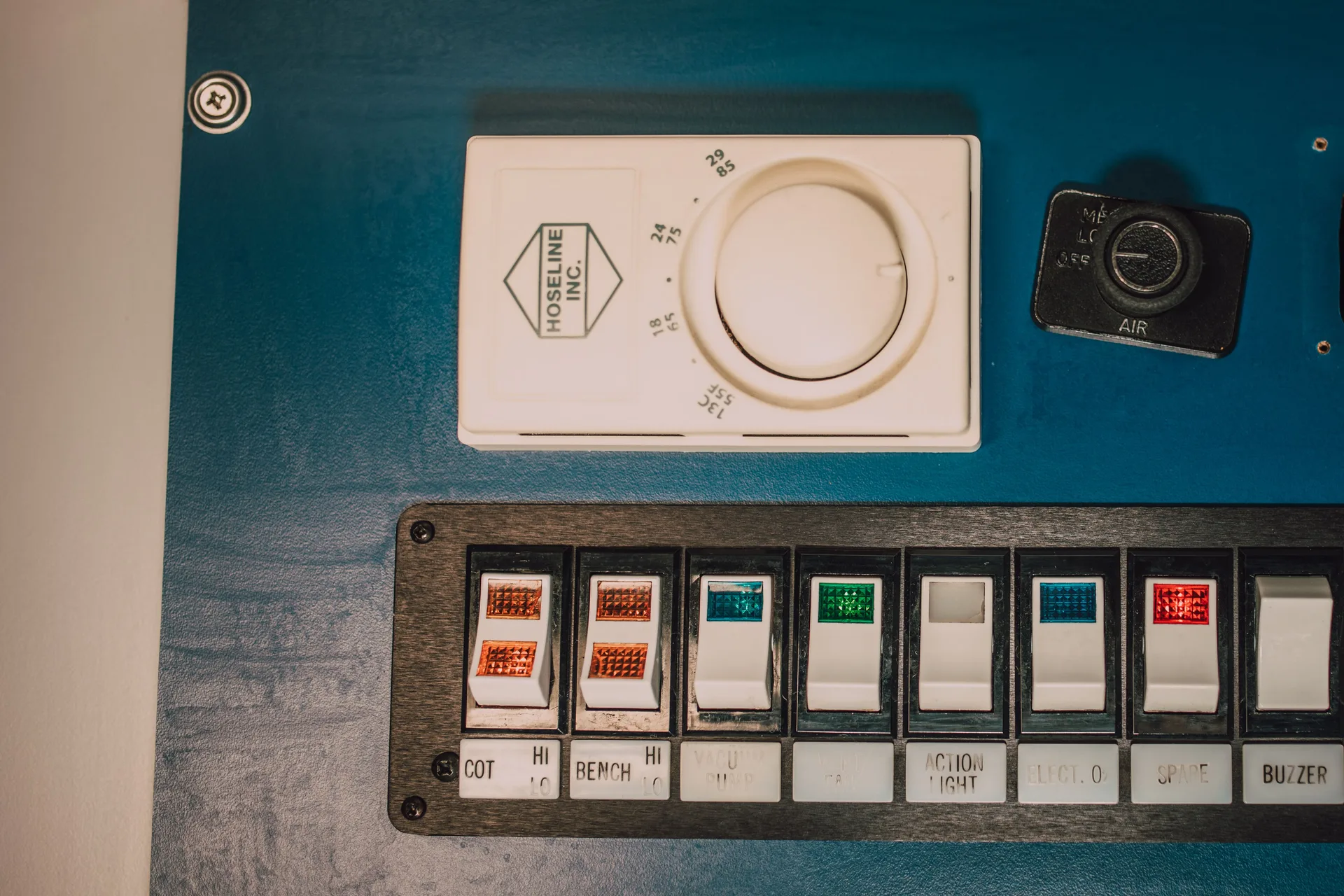 Close-up of a control panel with switches and a dial