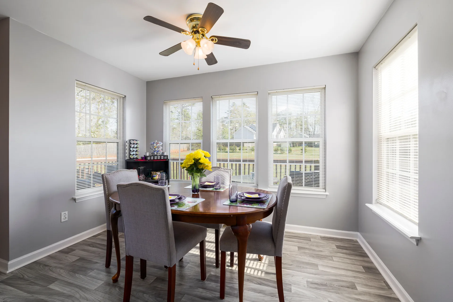 A ceiling fan above a dining table in a bright room
