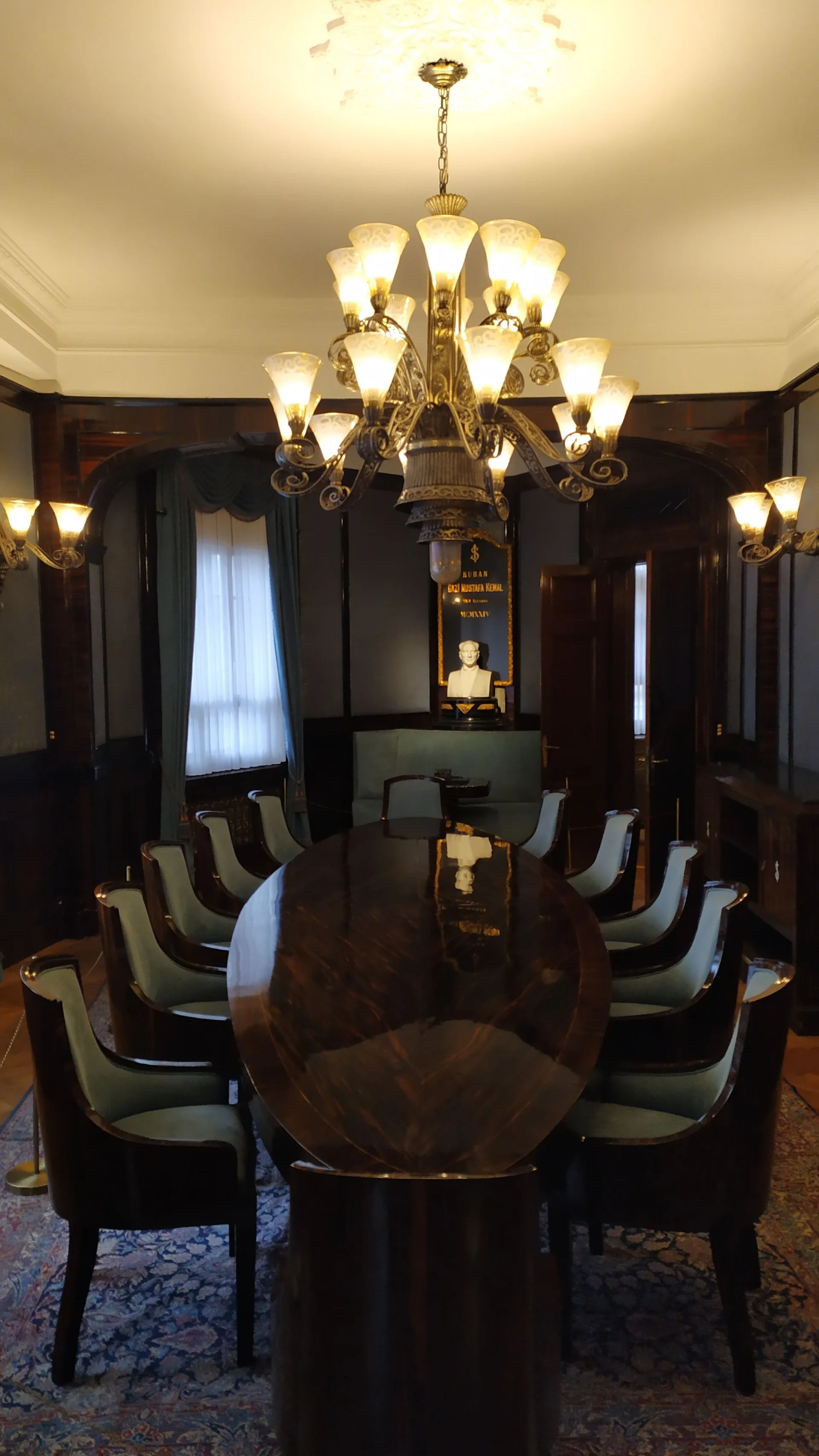 A grand chandelier over a polished wooden dining table