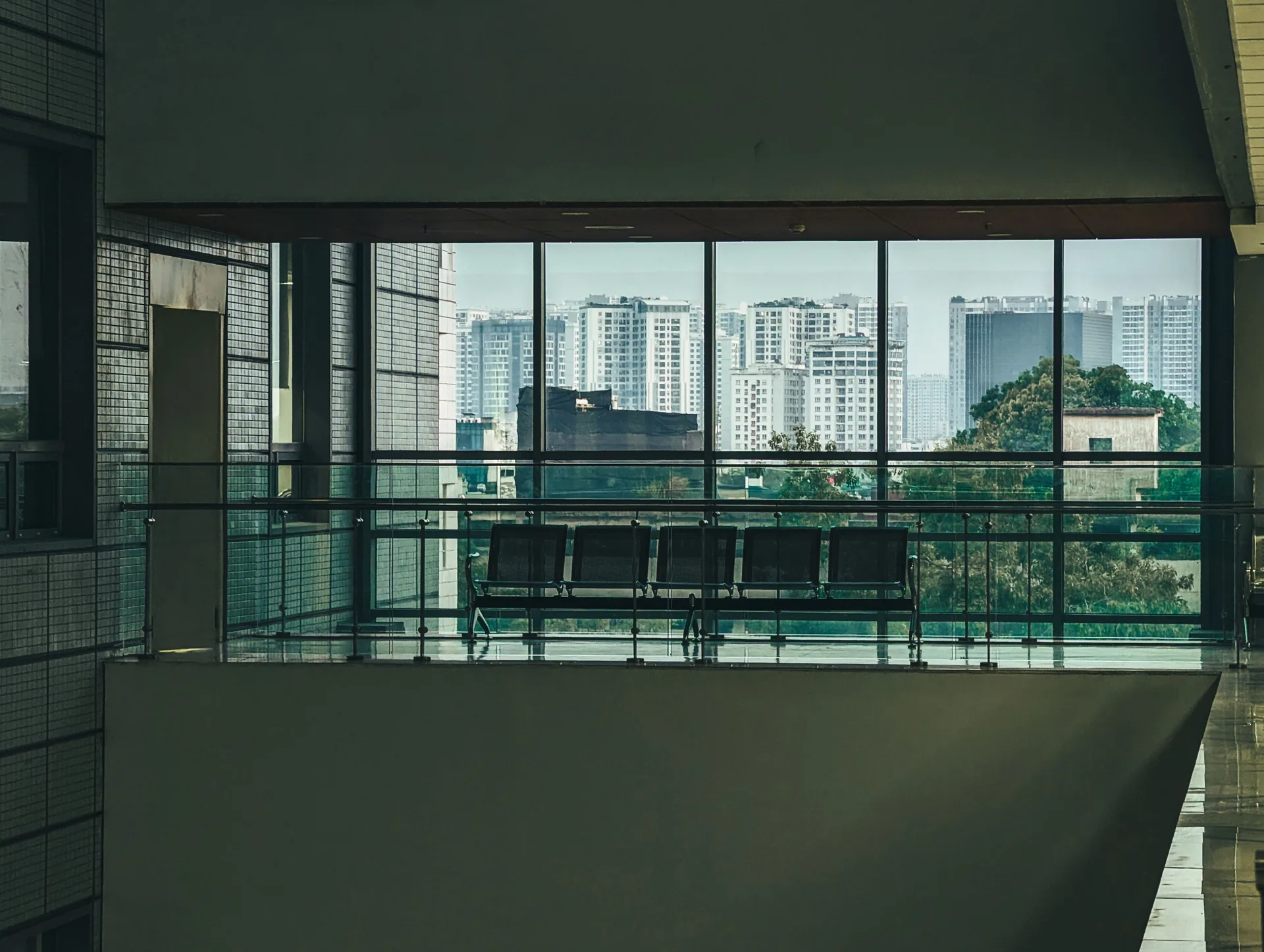 A spacious office interior with a large window and city view