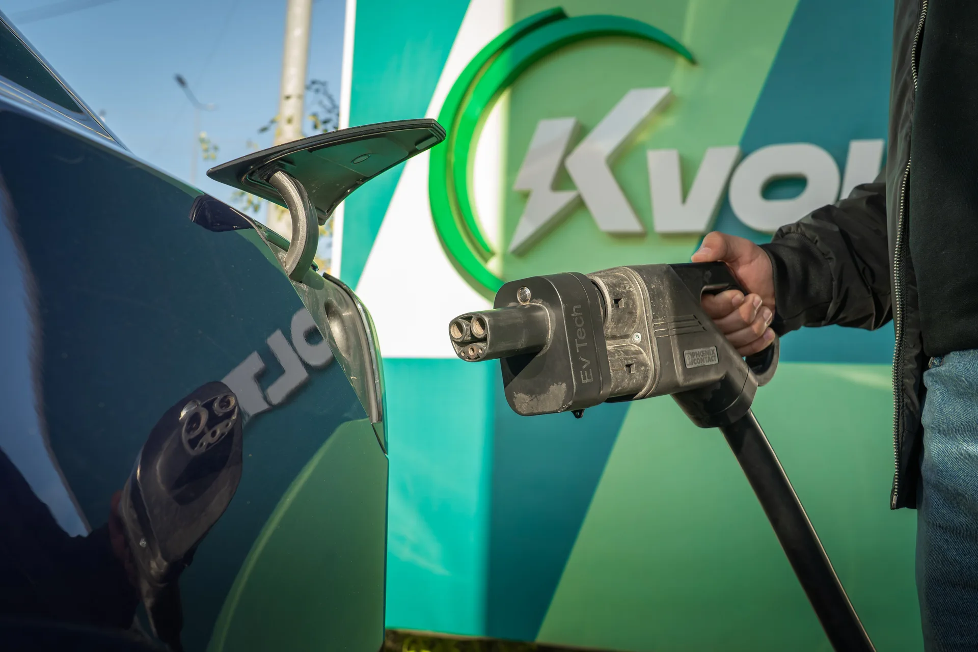 A close-up of an electric car being charged at a station