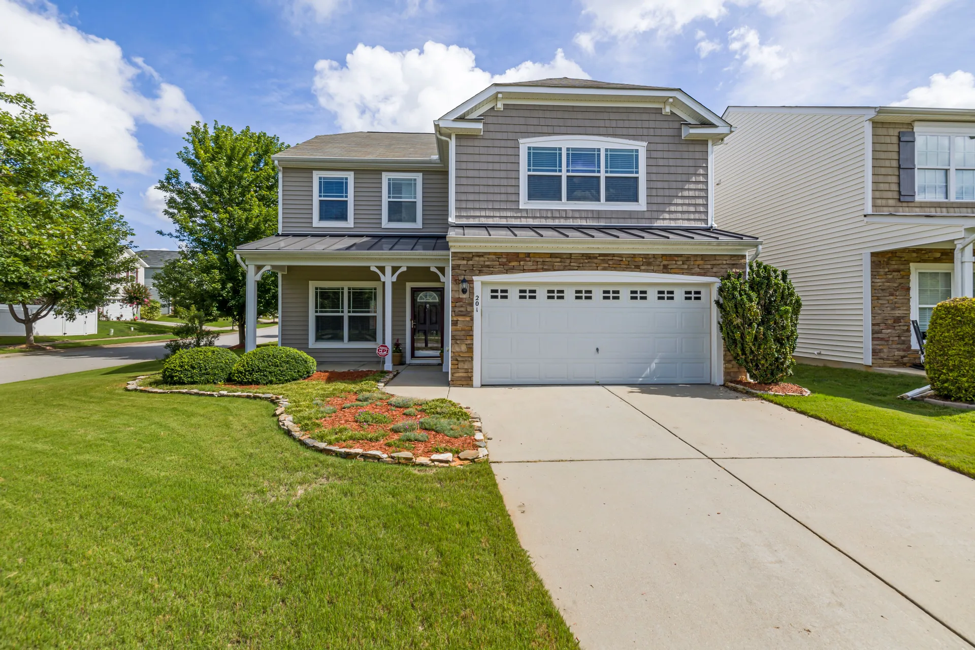 Suburban house facade with a tidy front yard in a residential neighborhood