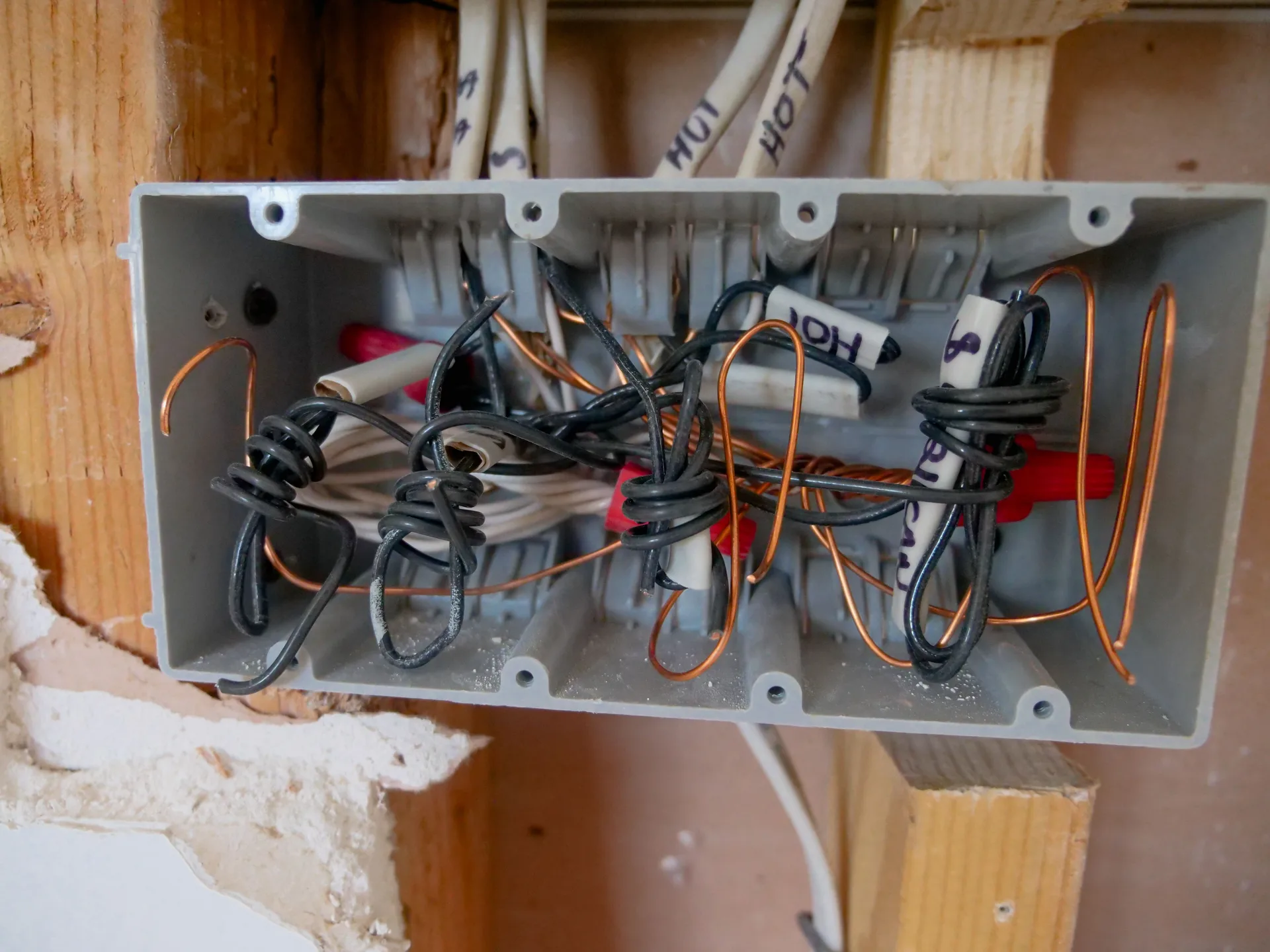 An open electrical switchboard with wires and cables