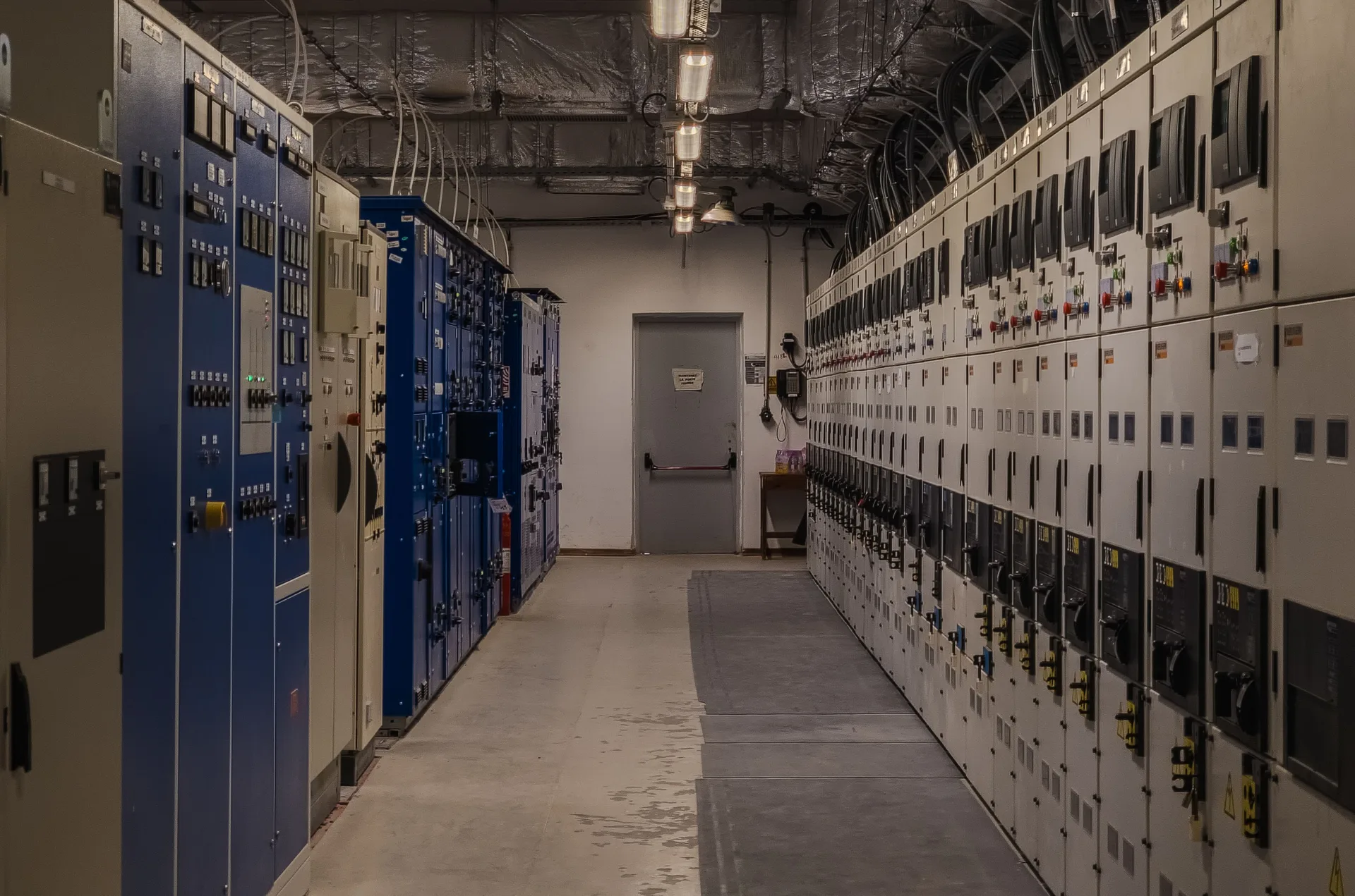 Industrial control room filled with electrical panels and equipment