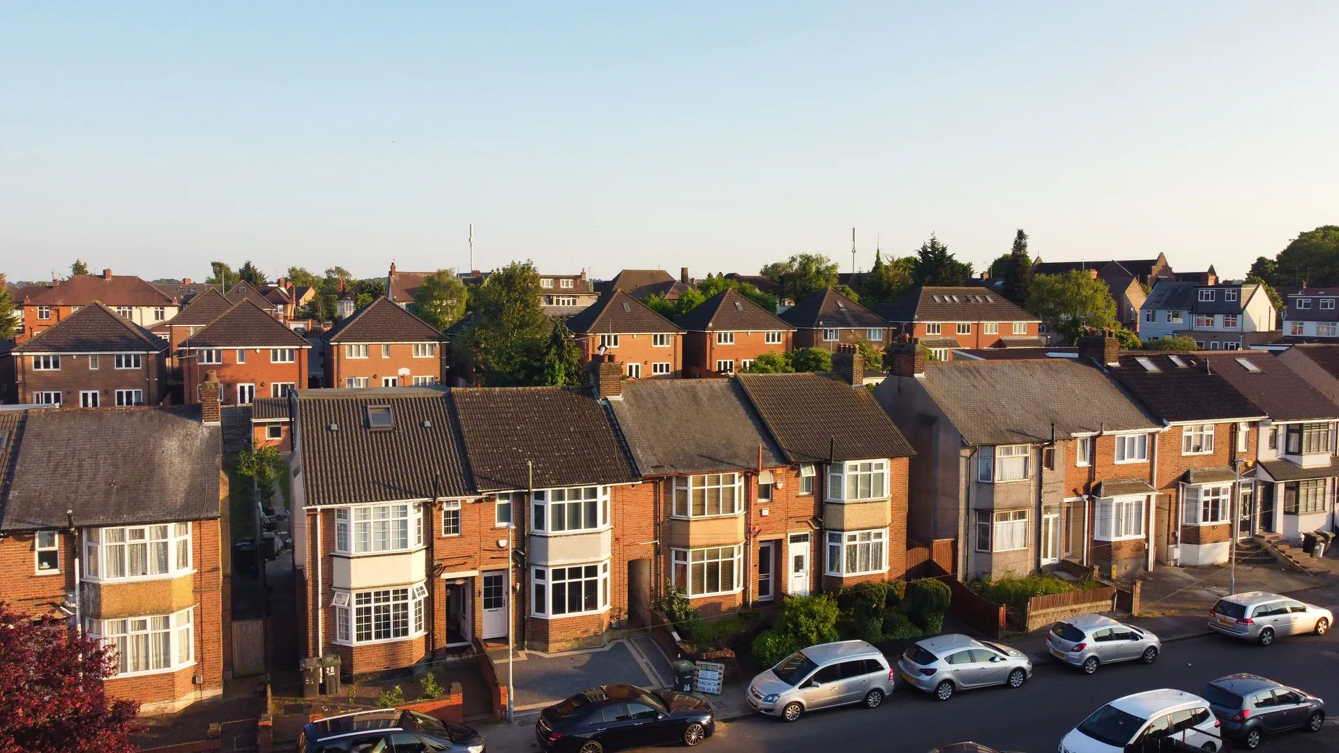 Aerial view of a residential neighborhood with brick houses on a sunny day